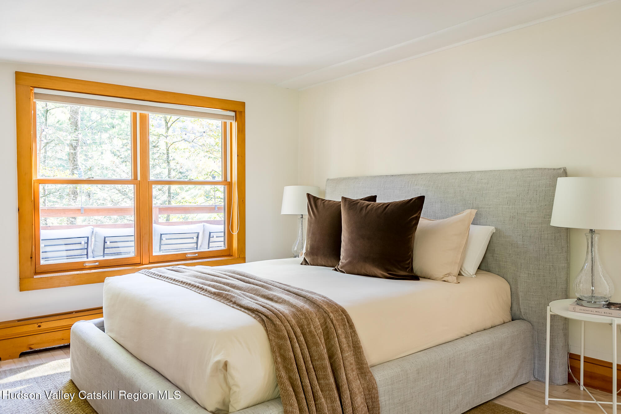 439 Silver Hollow Road Chichester, NY 12416 - Photo 13 of 36 a bedroom with a large bed and a lamp next to a window
