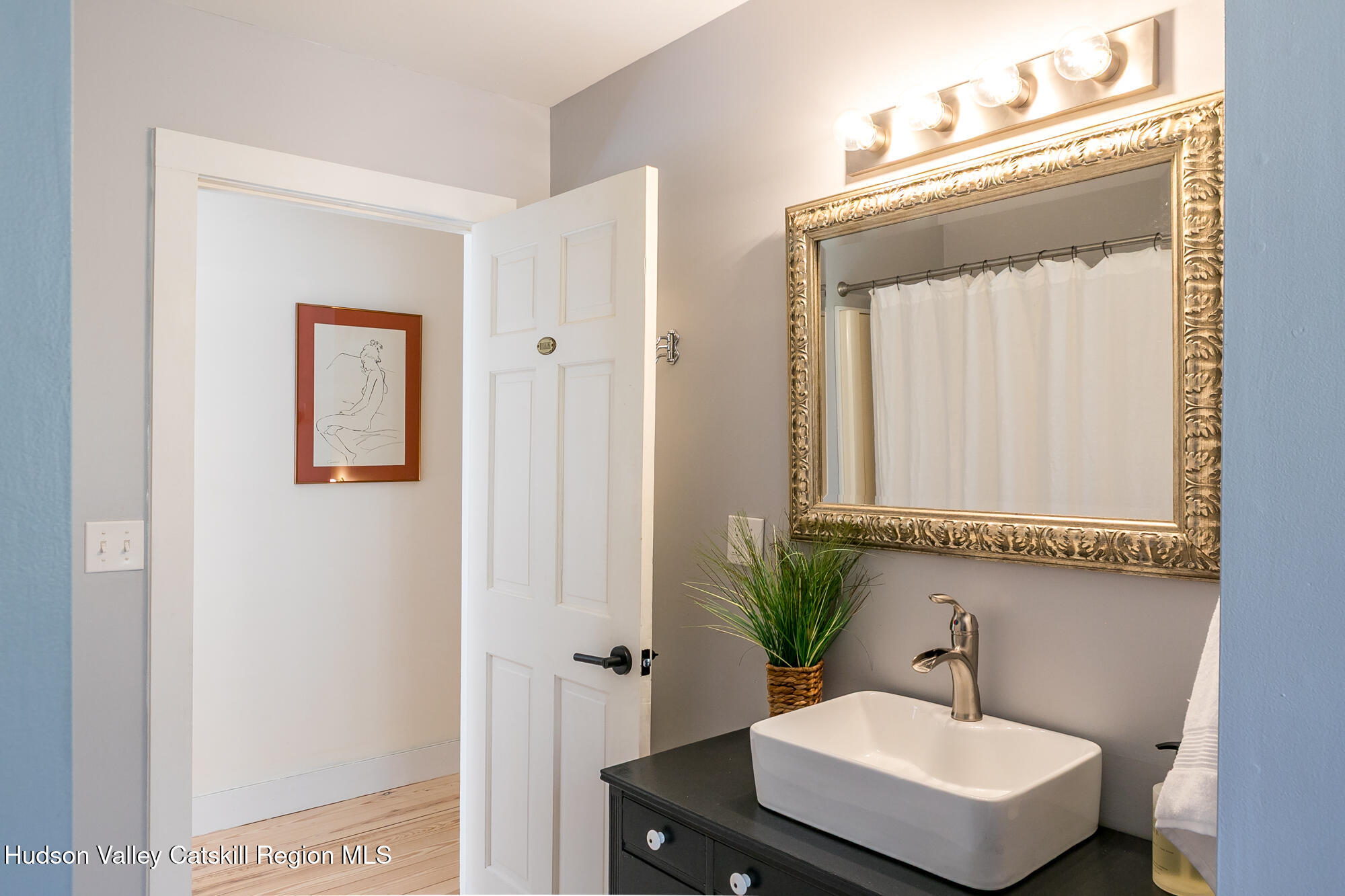 439 Silver Hollow Road Chichester, NY 12416 - Photo 19 of 36 a bathroom with a sink a mirror and a shower