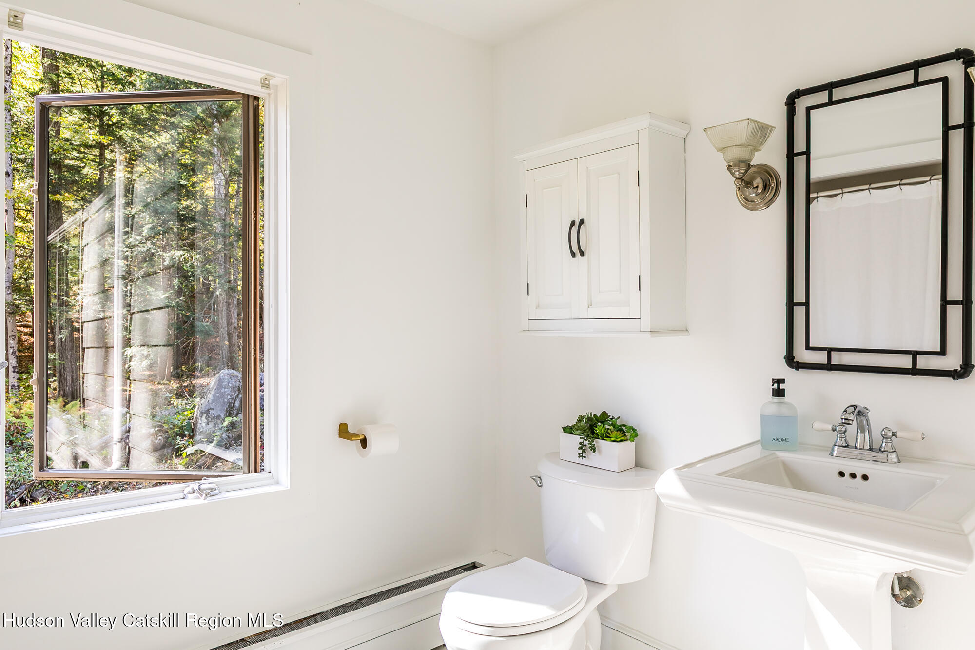 439 Silver Hollow Road Chichester, NY 12416 - Photo 23 of 36 a bathroom with a sink a toilet and a mirror