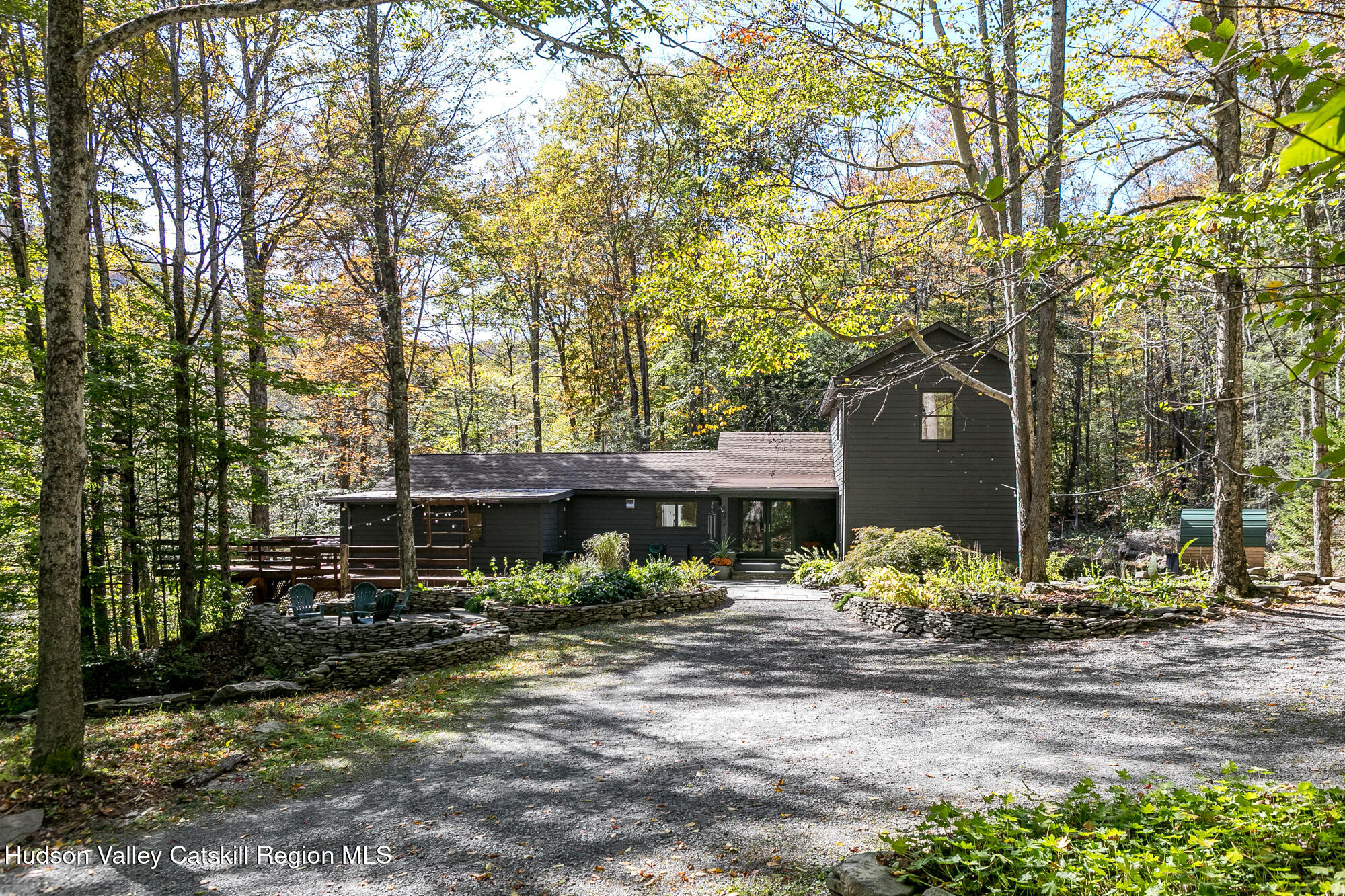 439 Silver Hollow Road Chichester, NY 12416 - Photo 29 of 36 a view of a patio with table and chairs under an umbrella