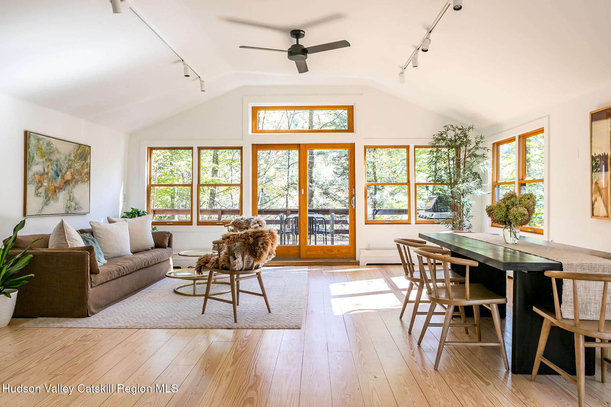 439 Silver Hollow Road Chichester, NY 12416 - Photo 4 of 36 a living room with furniture a wooden floor and floor to ceiling windows