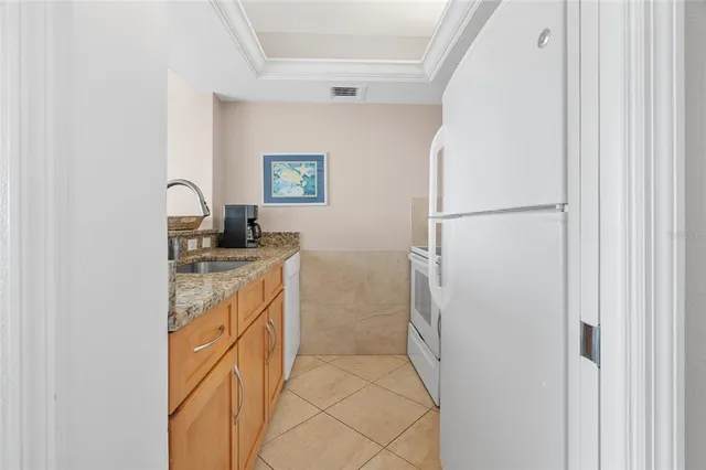 a kitchen with a refrigerator and a sink