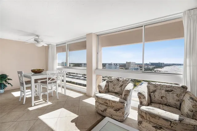 a living room with furniture and view of kitchen