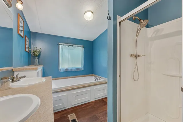 a view of a patio with table and chairs with wooden floor and fence