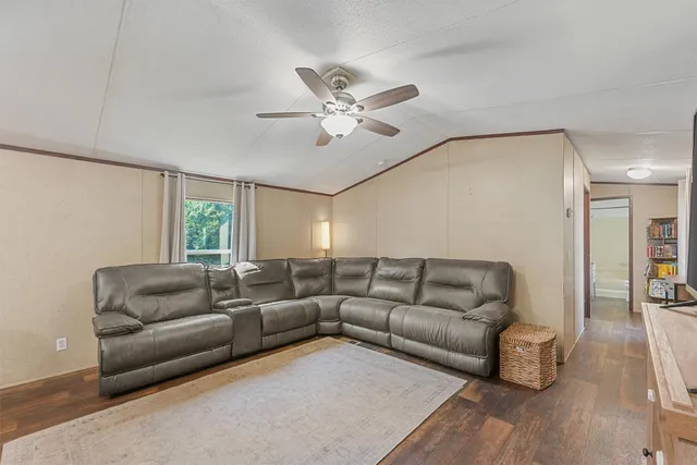 a living room with furniture and kitchen view