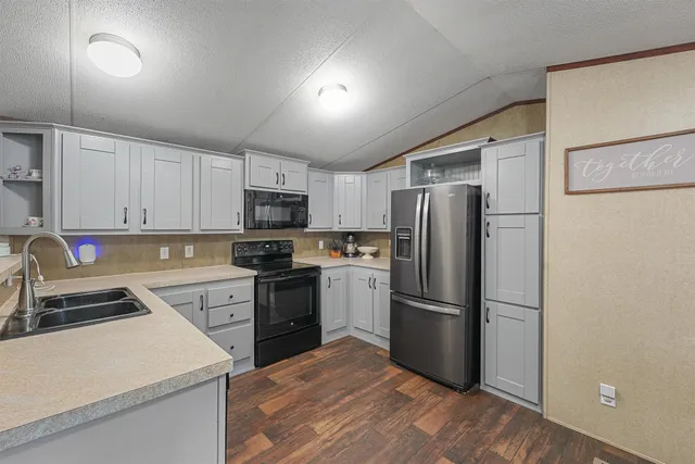 a kitchen with a stove a sink and a refrigerator