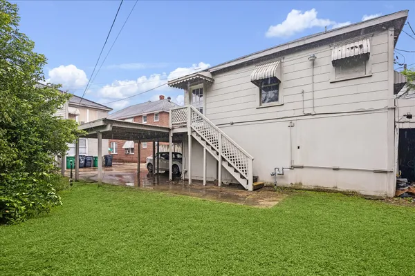 a view of a house with a yard and sitting area