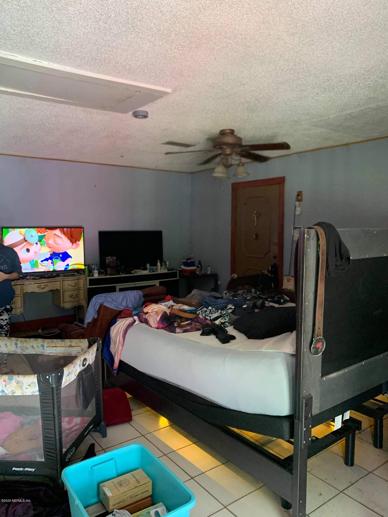 2385 Pellicer Road St. Augustine, FL 32092 - Photo 14 of 38 a bed room with a bed and a television