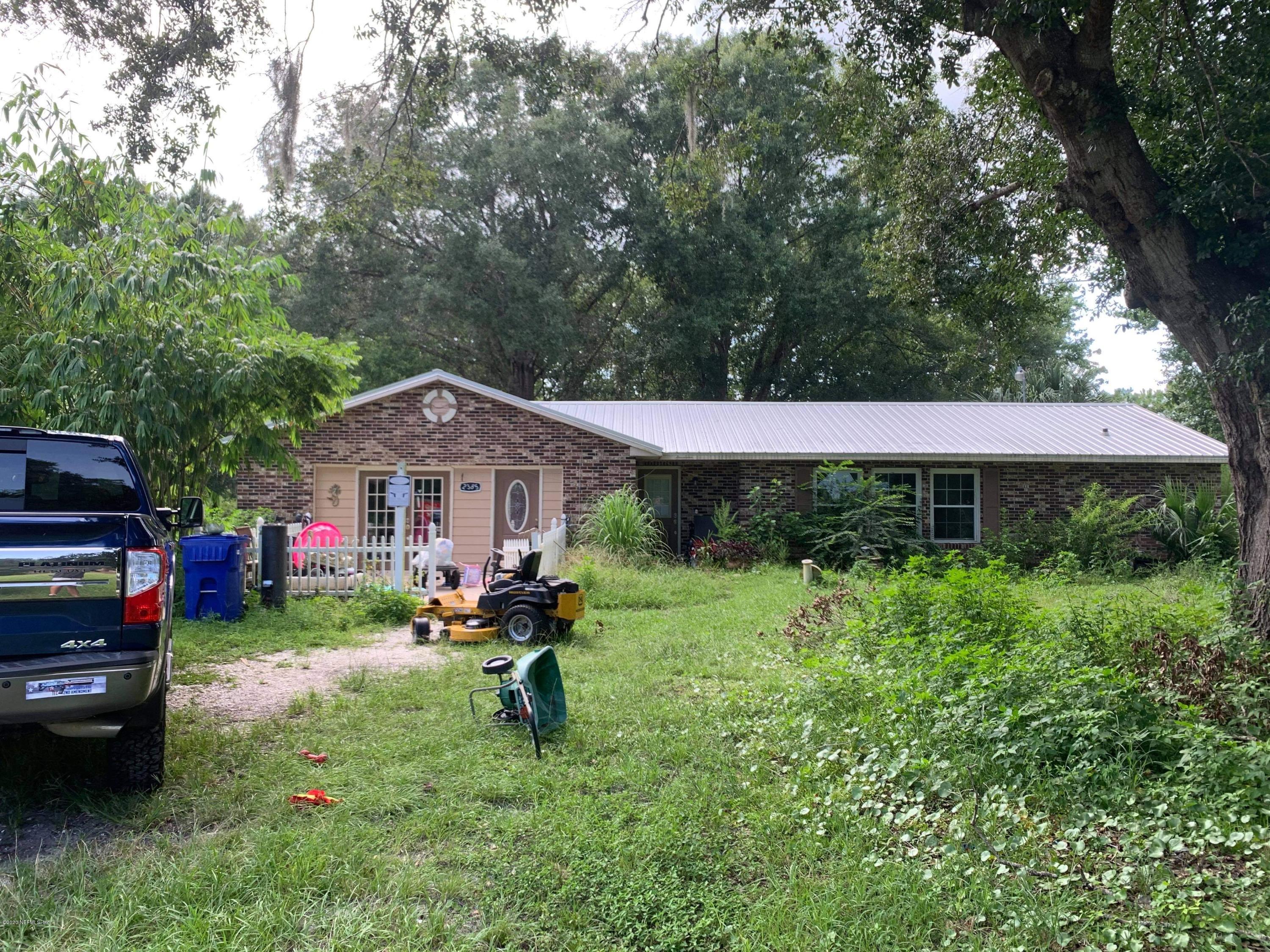 2385 Pellicer Road St. Augustine, FL 32092 - Photo 2 of 38 a backyard of a house with table and chairs