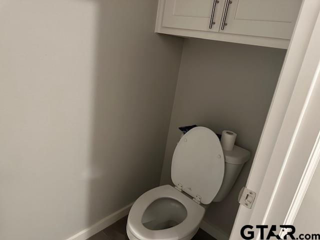 16461 County Road 178, Unit 4 Tyler, TX 75703 - Photo 13 of 16 a bathroom with a toilet and a mirror
