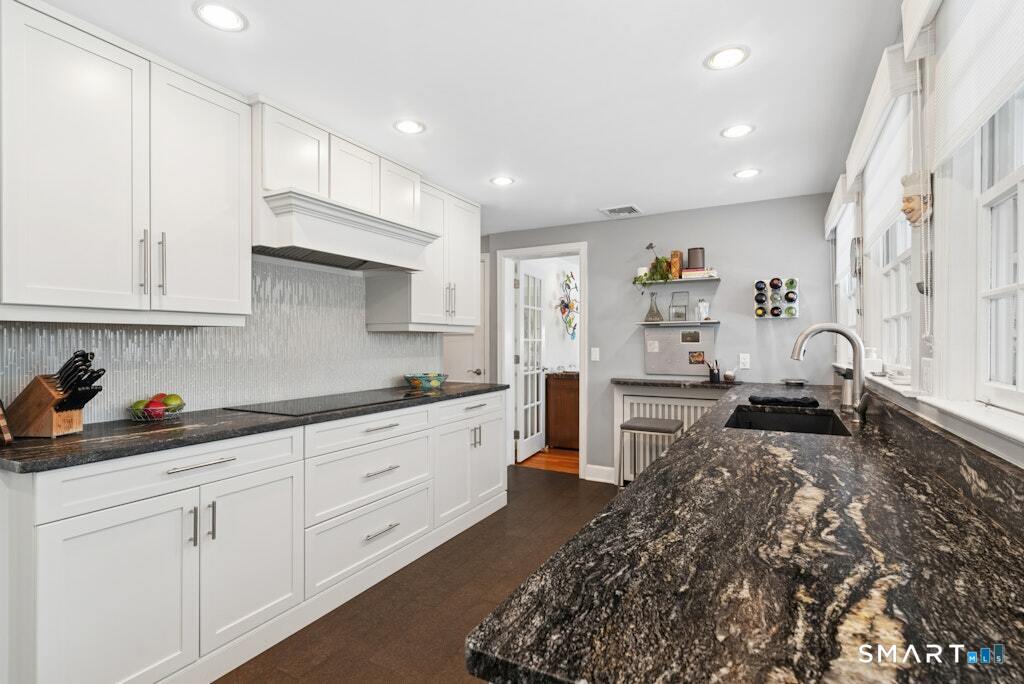 30 Windy Ridge Place Trumbull, CT 06611 - Photo 11 of 39 Granite counters with leathered finish, undermount sink and cork flooring.