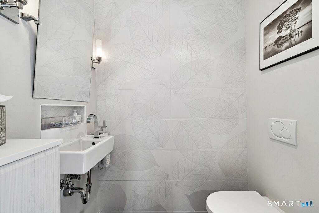 30 Windy Ridge Place Trumbull, CT 06611 - Photo 16 of 39 First floor powder room with tiled accent wall.