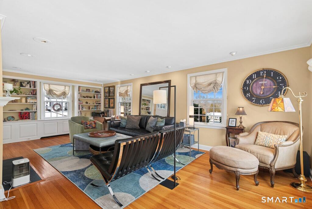 30 Windy Ridge Place Trumbull, CT 06611 - Photo 7 of 39 Living room with built in bookcases, crown molding and hardwood flooring.