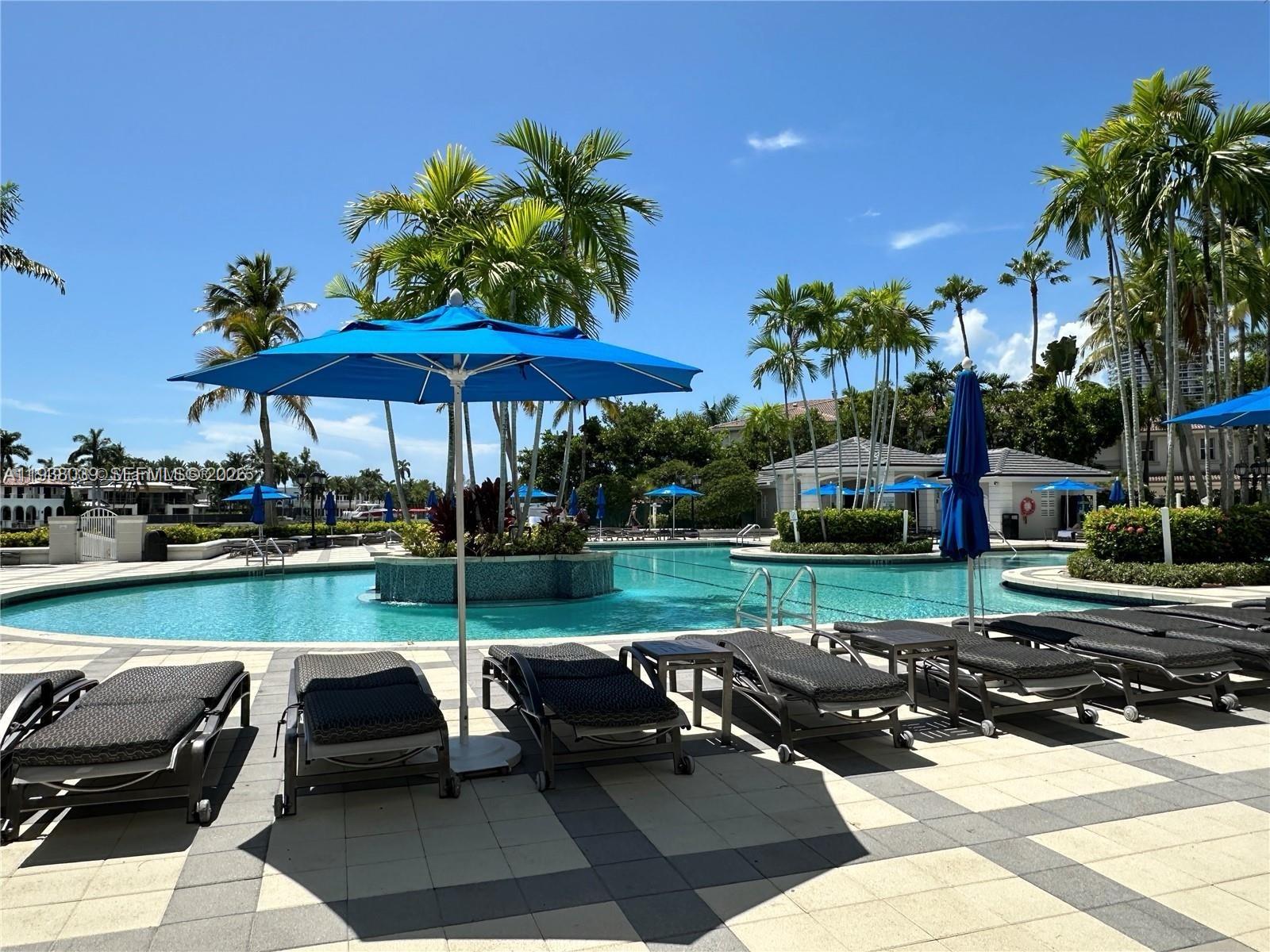 21200 Point Place, Unit 404 Aventura, FL 33180 - Photo 22 of 22 a view of a swimming pool and lounge chairs in patio