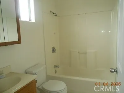 a bathroom with a shower a toilet and a sink