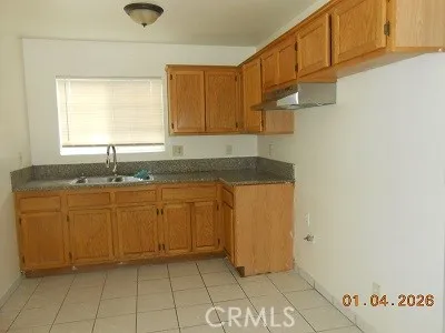 a kitchen with granite countertop a sink and a stove