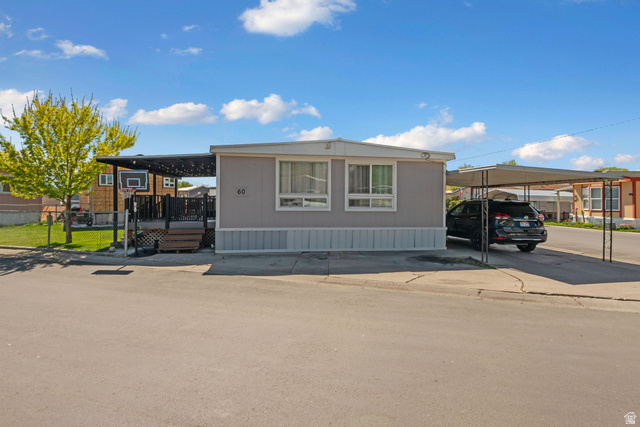 255 North 1600 West, Unit 60 Provo, UT 84601 - Photo 21 of 22 Manufactured / mobile home with a wooden deck and a carport