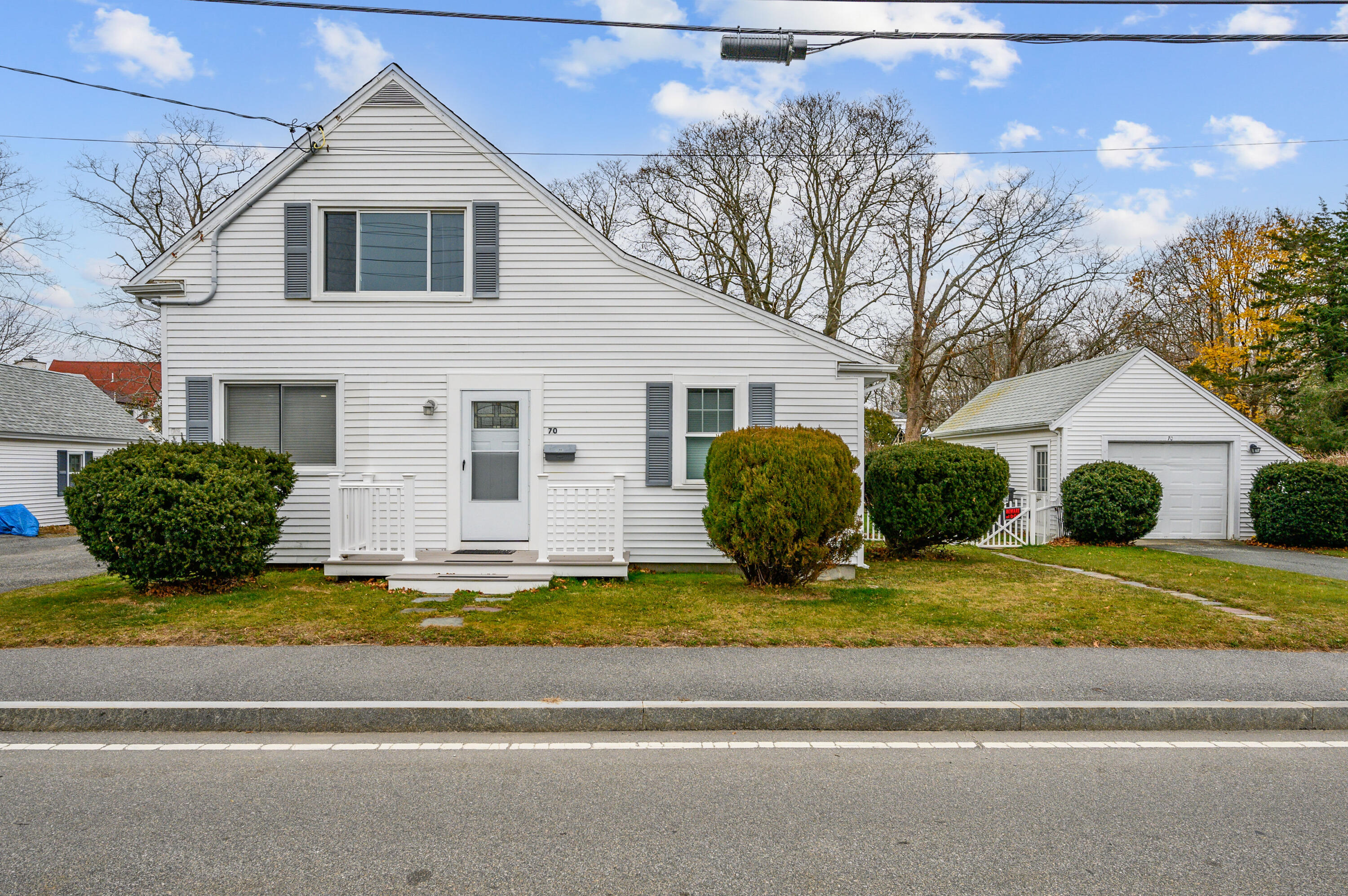 a view of a house with a yard and large tree