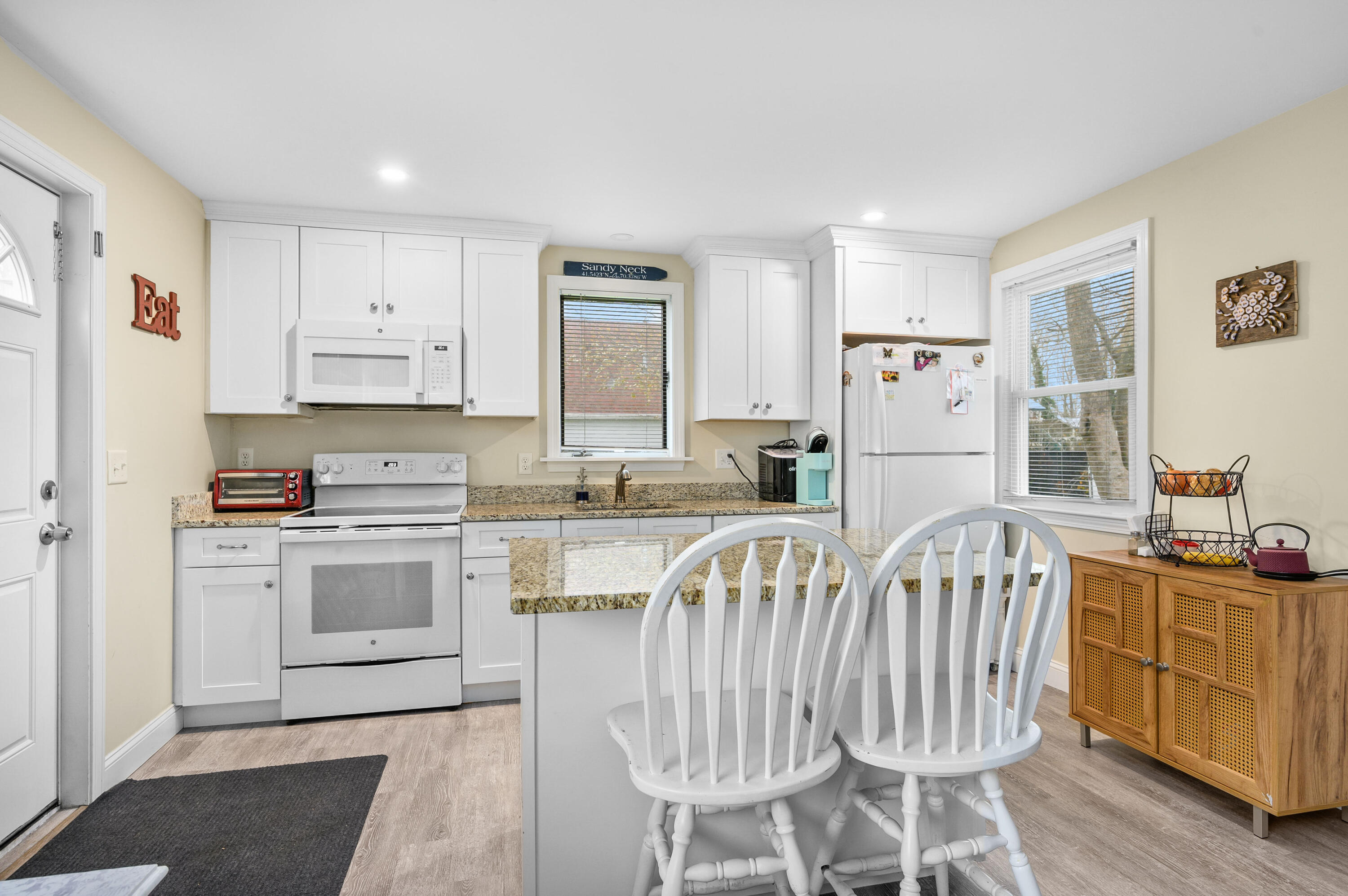 70 High School Road Hyannis, MA 02601 - Photo 16 of 23 a kitchen with white cabinets and stainless steel appliances