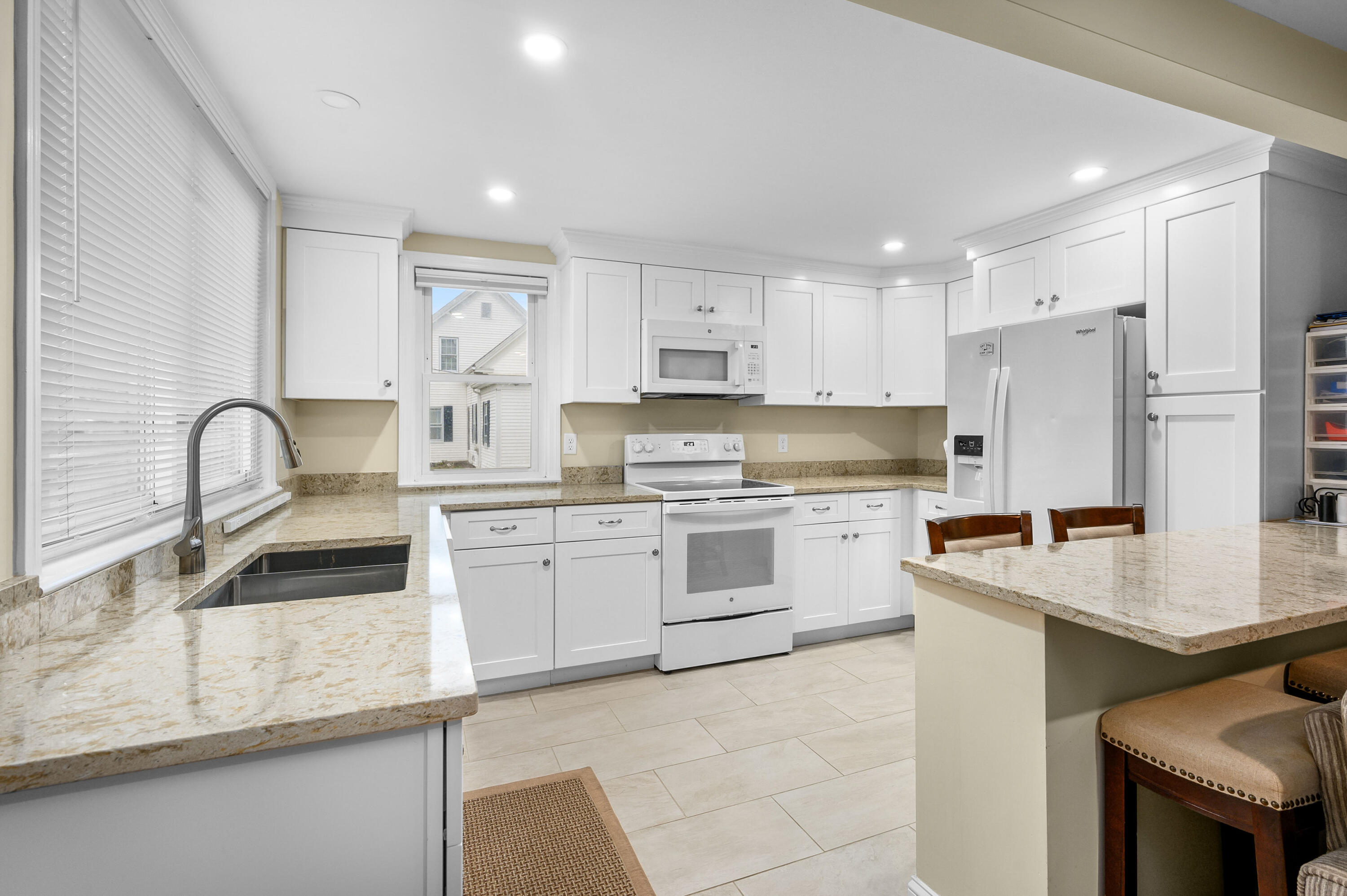 70 High School Road Hyannis, MA 02601 - Photo 2 of 23 a kitchen with granite countertop white cabinets and white appliances