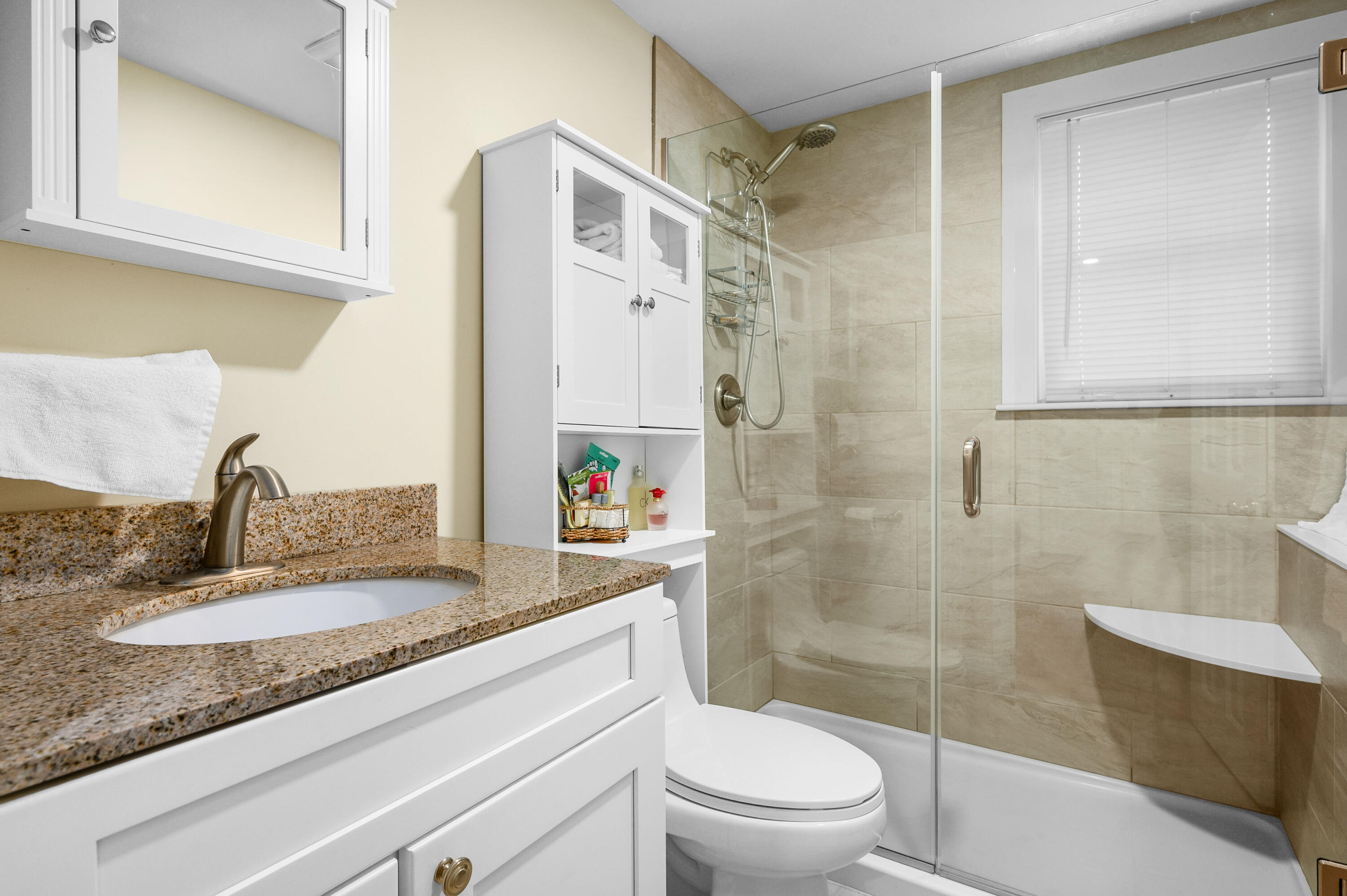 70 High School Road Hyannis, MA 02601 - Photo 6 of 23 a bathroom with a granite countertop sink toilet and shower