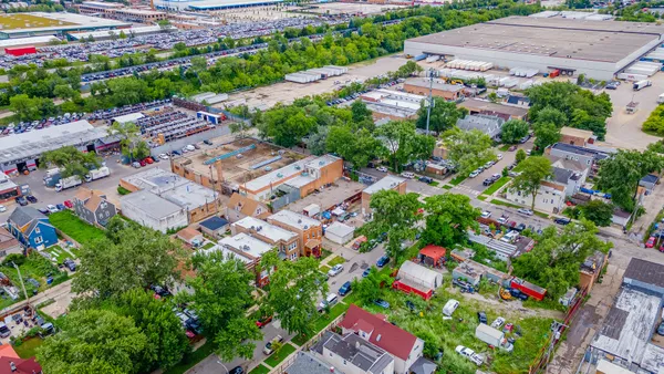 an aerial view of residential houses with outdoor space and street view