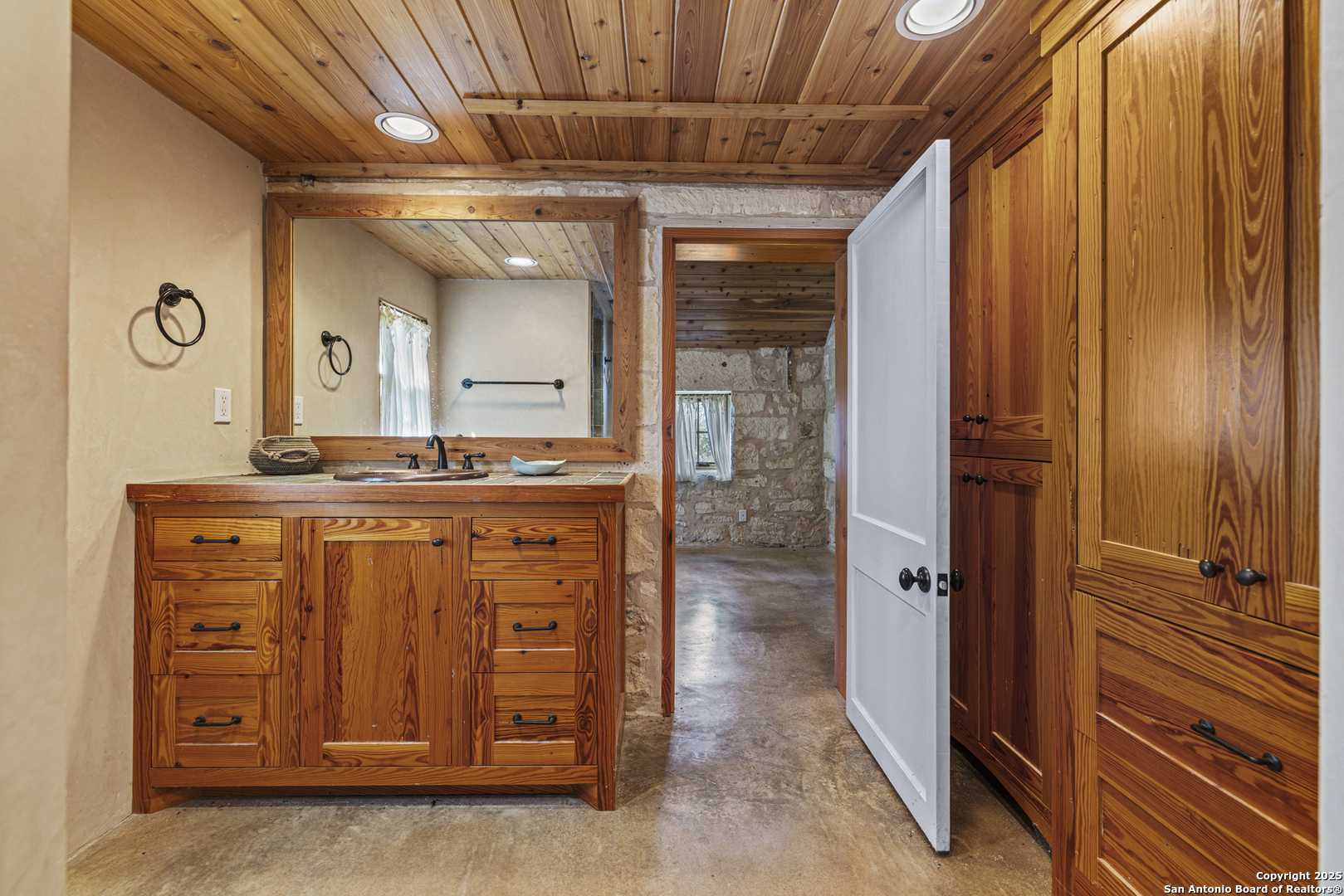 9402 Doss-Spring Creek Road Doss, TX 78618 - Photo 20 of 42 a bathroom with a granite countertop sink a mirror and a shower
