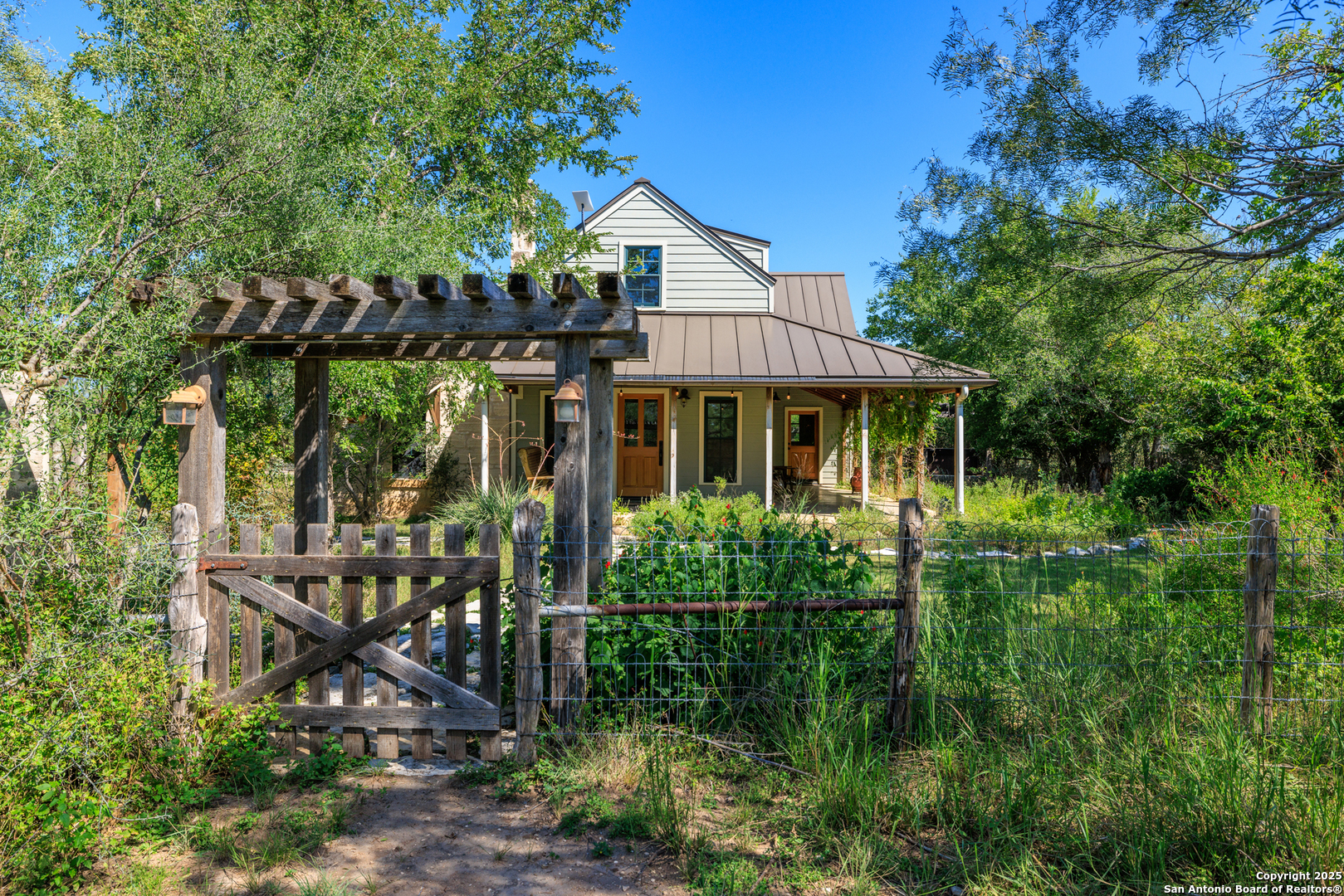 9402 Doss-Spring Creek Road Doss, TX 78618 - Photo 2 of 42 a view of a house with backyard sitting area and garden