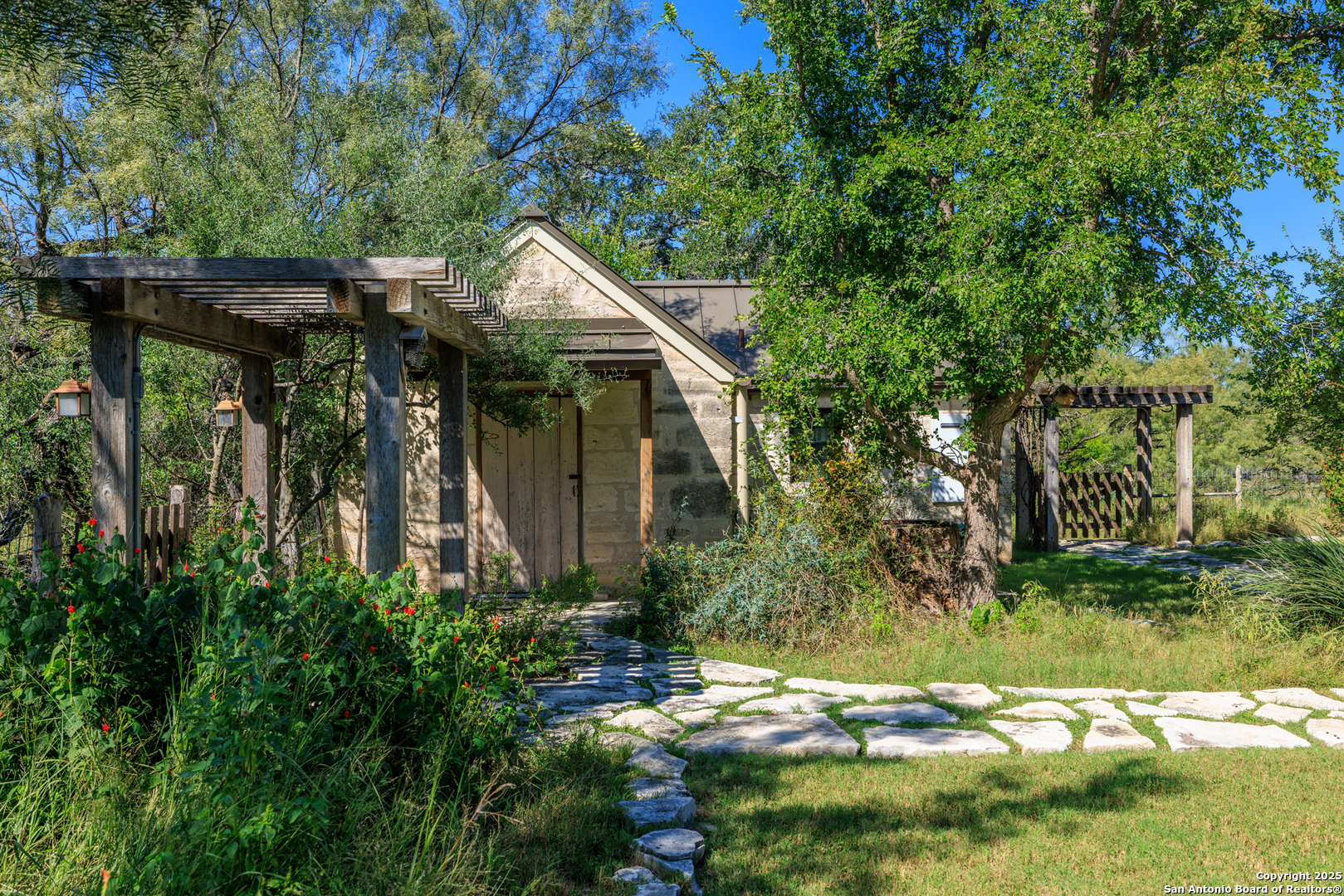 9402 Doss-Spring Creek Road Doss, TX 78618 - Photo 24 of 42 a backyard of a house with lots of green space