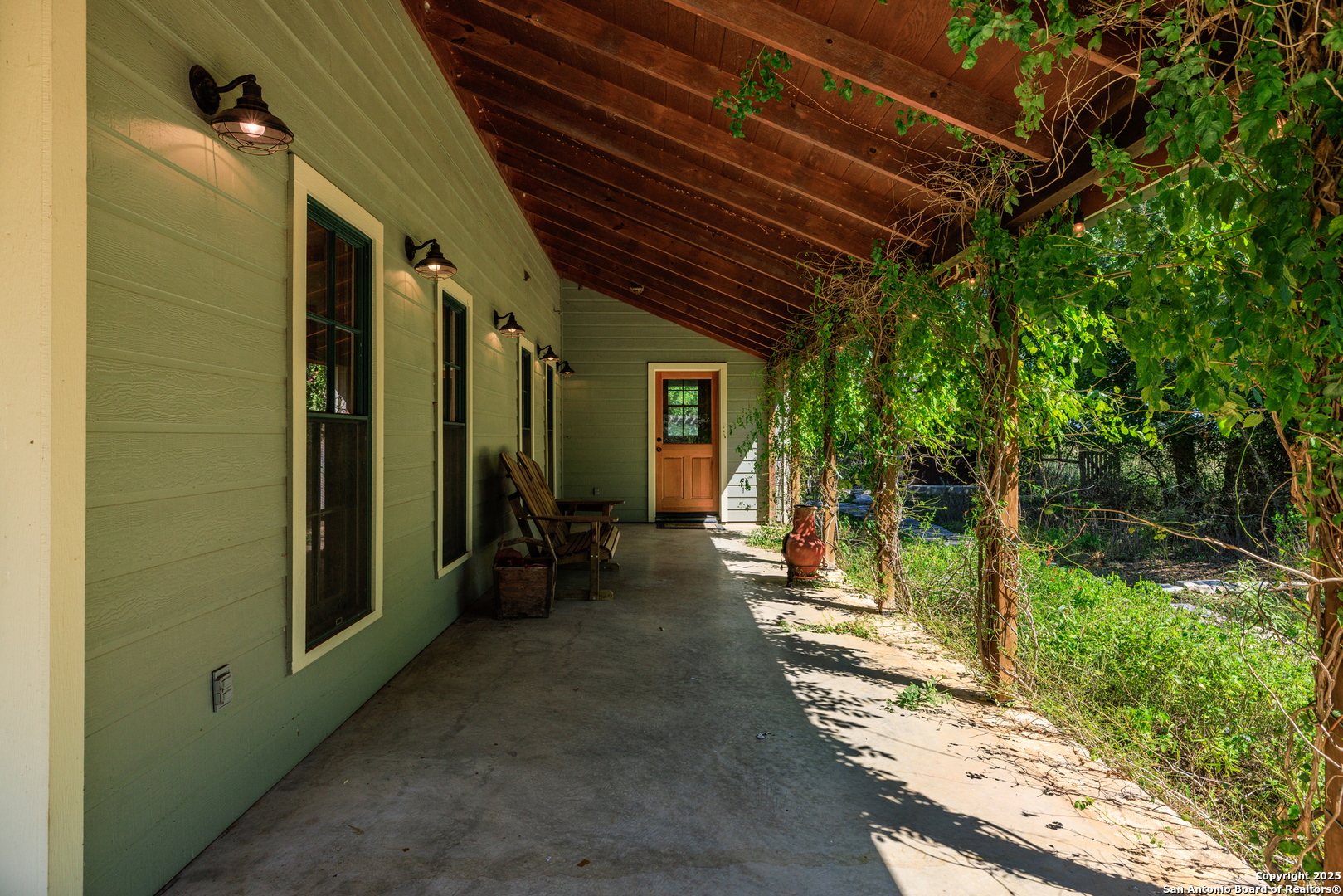 9402 Doss-Spring Creek Road Doss, TX 78618 - Photo 26 of 42 a view of a porch with furniture and a yard