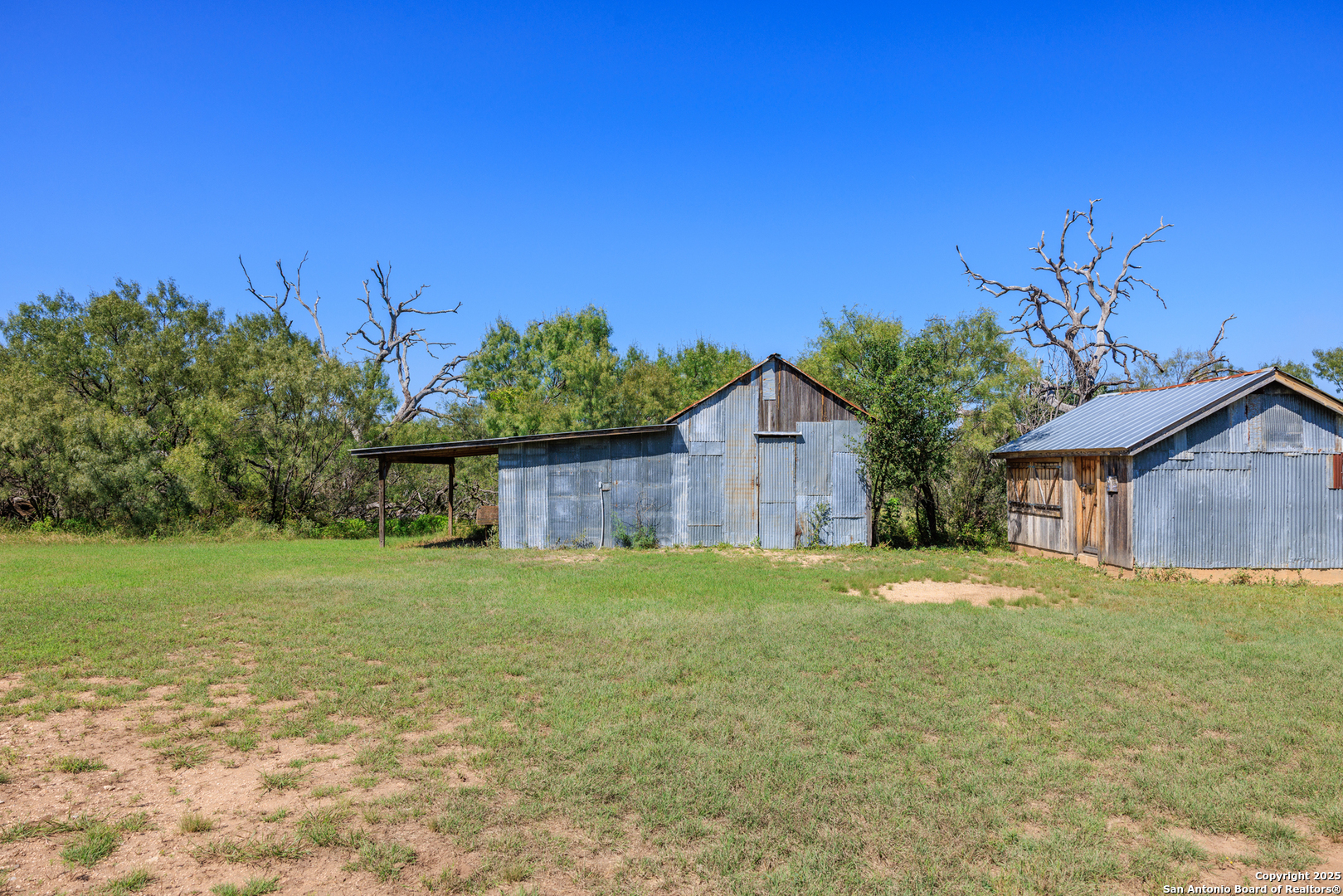 9402 Doss-Spring Creek Road Doss, TX 78618 - Photo 34 of 42 a front view of a house with a yard and garage
