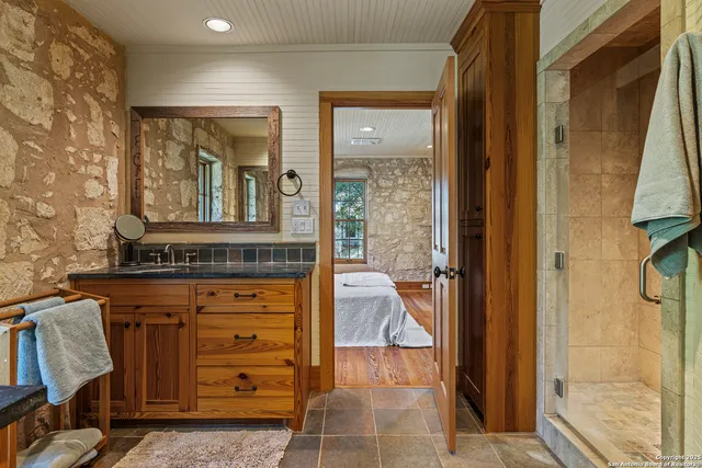 a bathroom with a granite countertop sink a vanity and a mirror