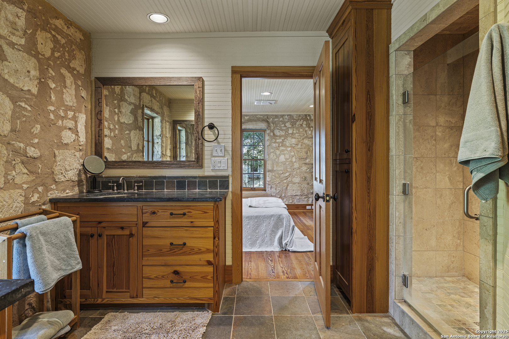 9402 Doss-Spring Creek Road Doss, TX 78618 - Photo 9 of 42 a bathroom with a granite countertop sink a vanity and a mirror