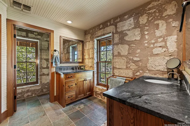 a kitchen with stainless steel appliances granite countertop a sink and a stove