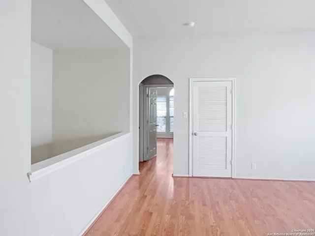 a view of a room with wooden floor and a bathroom