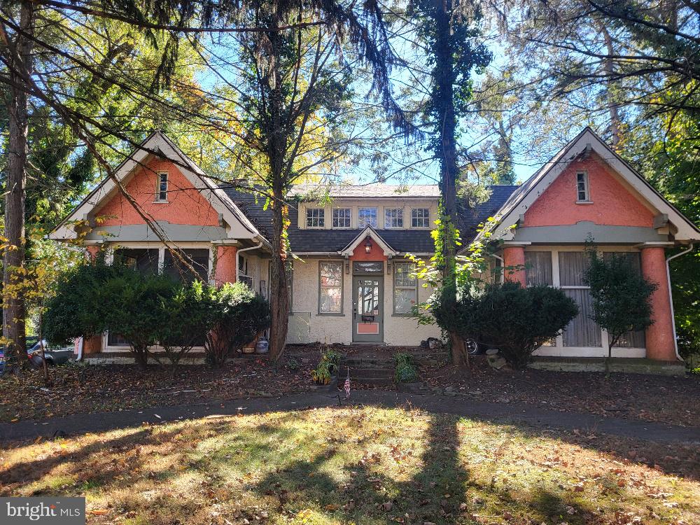 10 Church Road Merchantville, NJ 08109 - Photo 4 of 15 a front view of a house with a yard garage and outdoor seating