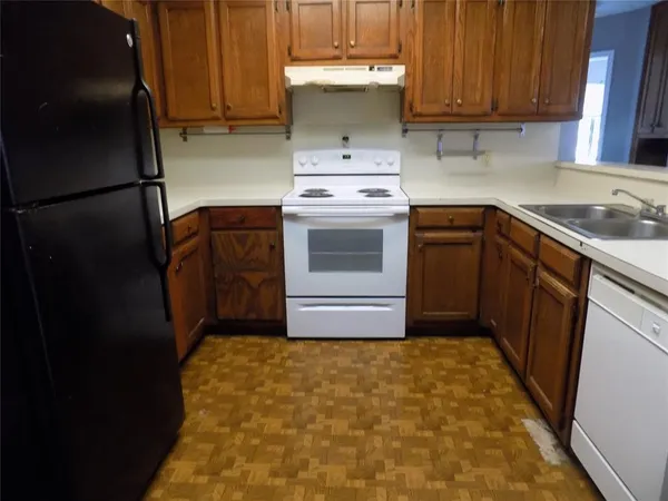 a kitchen with a stove top oven and cabinets