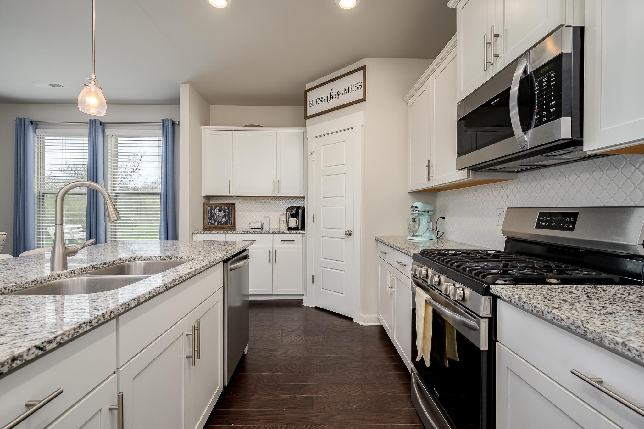 3130 Rift Lane Murfreesboro, TN 37130 - Photo 6 of 31 a kitchen with stainless steel appliances granite countertop a sink stove microwave and refrigerator