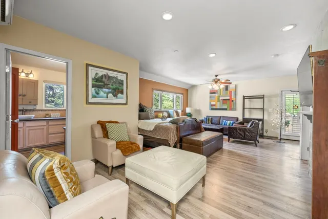 a living room with furniture and a wooden floor