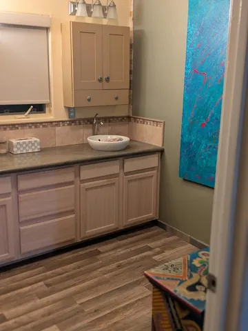 a bathroom with a granite countertop sink mirror and vanity