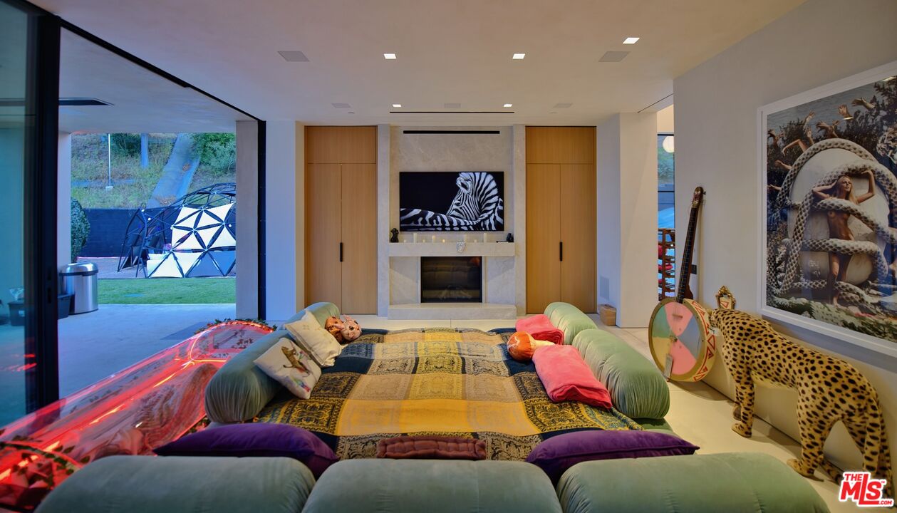 11531 Orum Road Los Angeles, CA 90049 - Photo 11 of 27 a bedroom with furniture and a flat screen tv