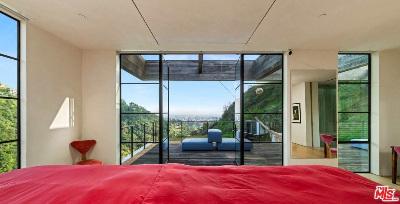11531 Orum Road Los Angeles, CA 90049 - Photo 13 of 27 a bedroom with a large bed and a large window