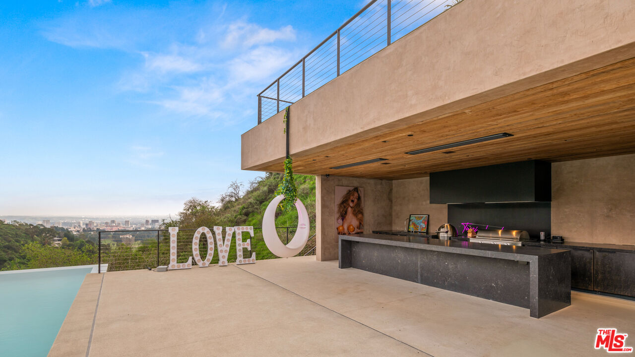 11531 Orum Road Los Angeles, CA 90049 - Photo 26 of 27 a view of a swimming pool with outdoor seating