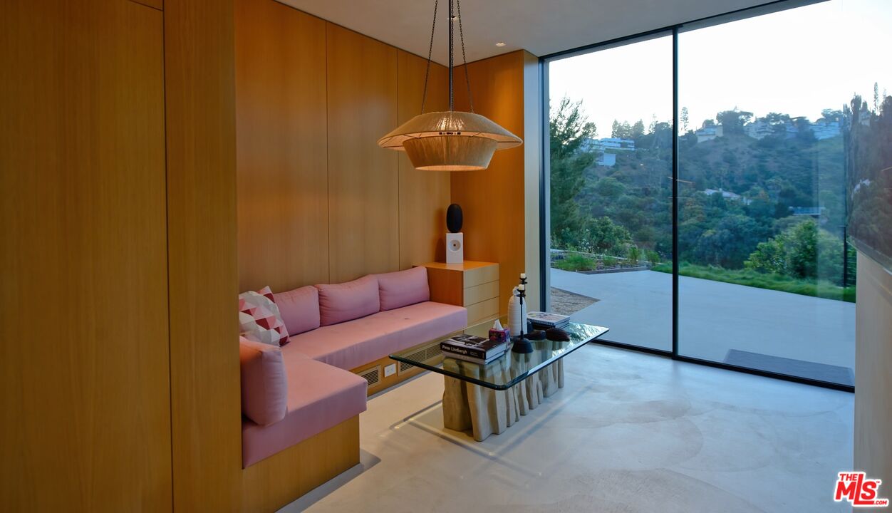 11531 Orum Road Los Angeles, CA 90049 - Photo 9 of 27 a living room with furniture and a floor to ceiling window