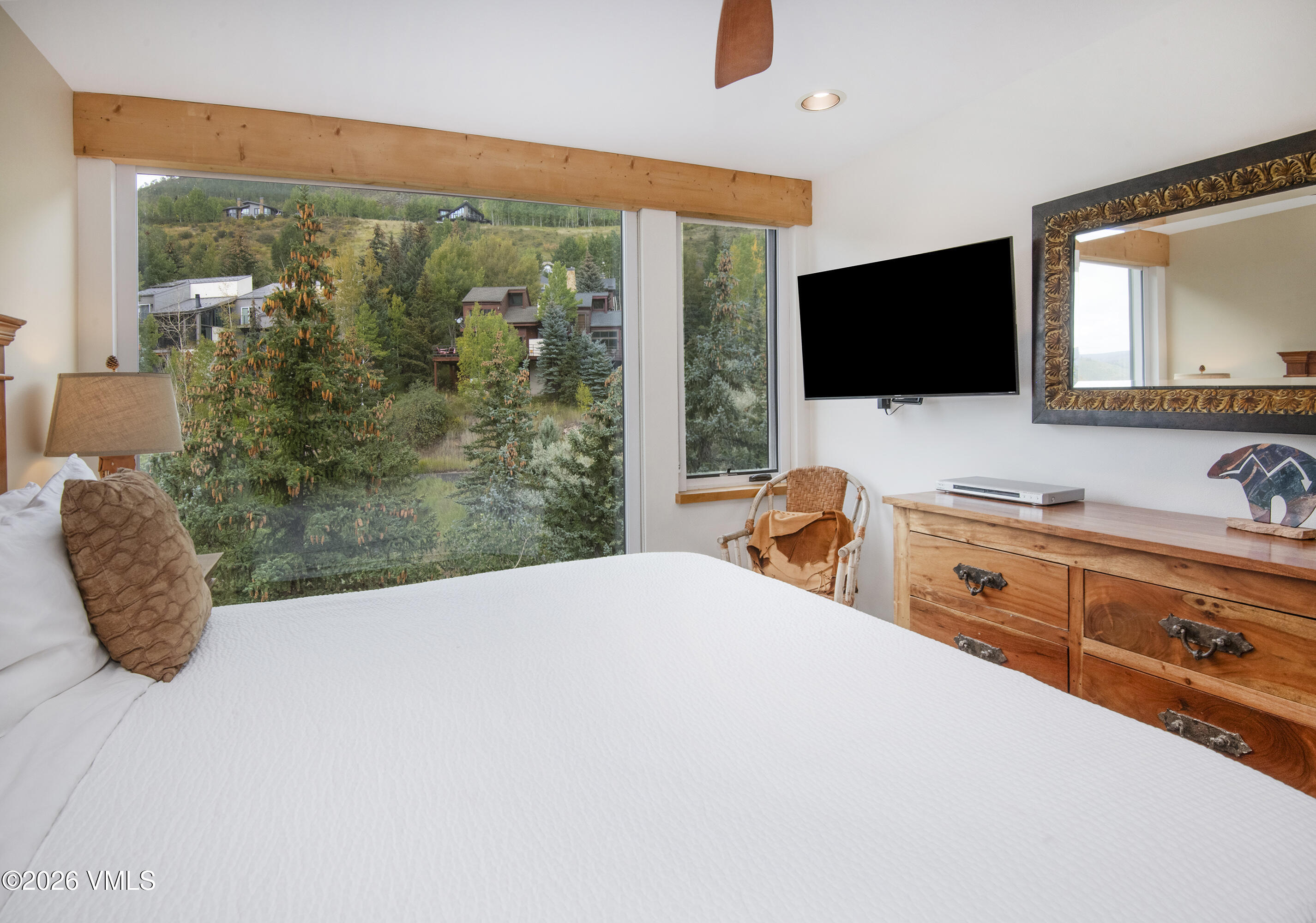 1100 North Frontage Road West, Unit 1519 Vail, CO 81657 - Photo 8 of 38 a bedroom with a large bed and a flat tv screen on dresser