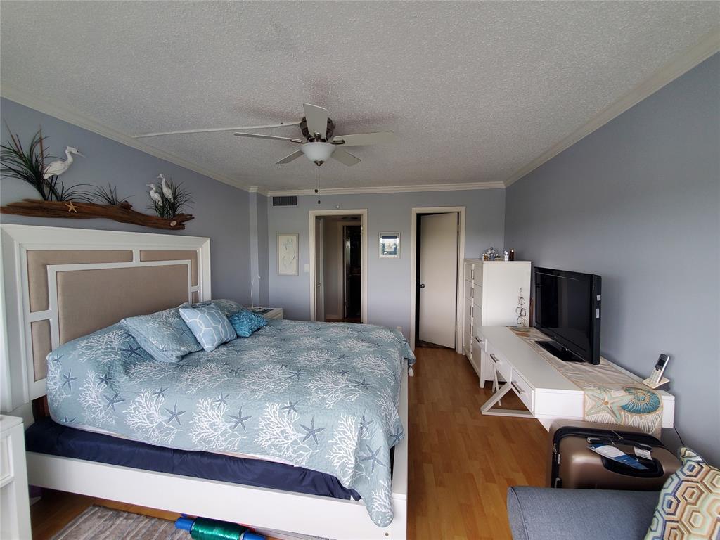 2611 North Riverside Drive, Unit 504 Pompano Beach, FL 33062 - Photo 20 of 35 a bedroom with a bed and a flat screen tv