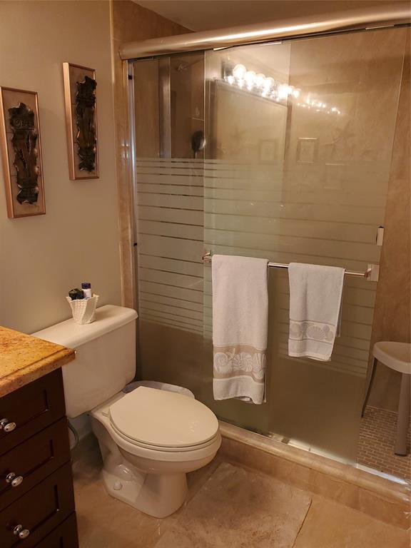 2611 North Riverside Drive, Unit 504 Pompano Beach, FL 33062 - Photo 22 of 35 a bathroom with a toilet and shower