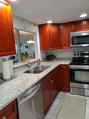 a bathroom with granite countertop double vanity and a mirror