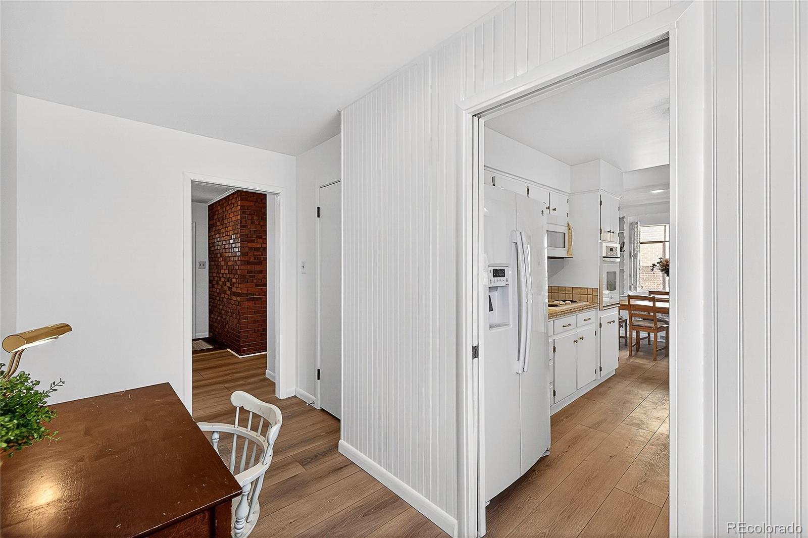 2768 South Mabry Way Denver, CO 80236 - Photo 15 of 39 a view of a kitchen with refrigerator and wooden floor