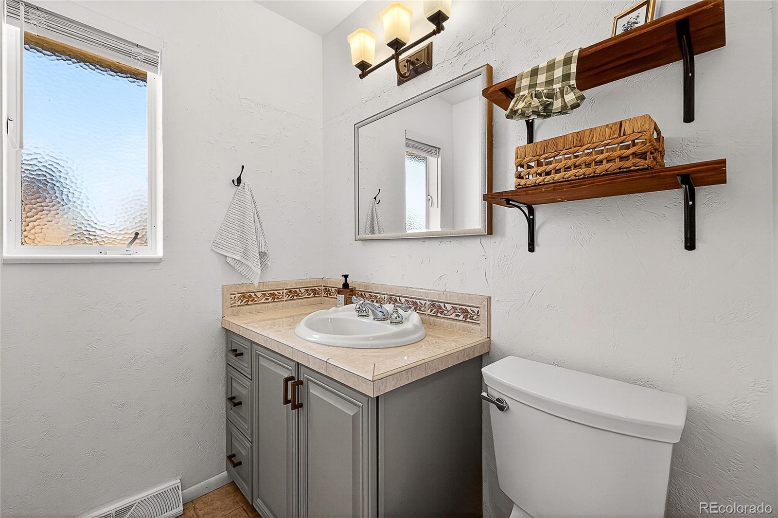 2768 South Mabry Way Denver, CO 80236 - Photo 16 of 39 a bathroom with a sink and a toilet